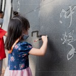 文學(xué)館一處的墨痕詩牆，開放大朋友與小朋友提筆、沾水，於黝黑的牆面體會親手落筆書寫的美好。