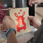 剛完成的剪紙，辛卯喜兔浮躍紙上，手捧著元寶寓意財(cái)源滾滾，家族發(fā)揮創(chuàng)意增添
兩顆小愛心，俏皮且生動(dòng)的趣味十足。