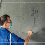 位處一隅的墨痕詩牆，開放大朋友與小朋友提筆、沾水，於黝黑的牆面體會親手落筆書寫的美好。